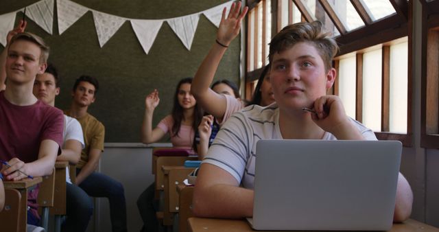 Engaged High School Students in Classroom with Raised Hands - Download Free Stock Images Pikwizard.com