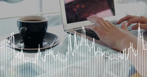 Hands typing on laptop with coffee and data overlay showing business analytics remote work