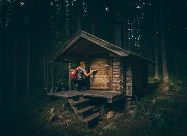 Explorer Opening Door of Wooden Cabin in Forest - Download Free Stock Photos Pikwizard.com