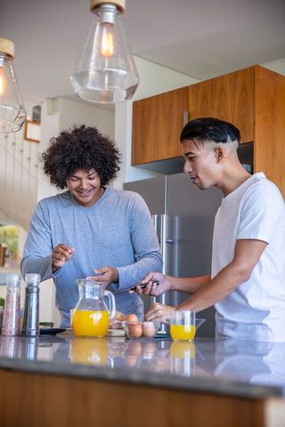 Father and Son Cooking Together Enjoying Breakfast at Home
