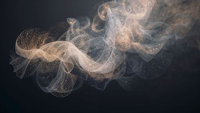 Luminescent mesh ribbon flowing with gold sparkle and ethereal dust on dark background