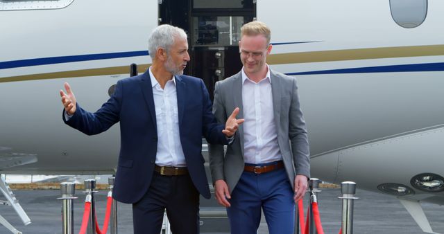 Business Executives Having Discussion in Front of Private Jet - Download Free Stock Images Pikwizard.com