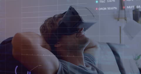 Man Experiencing Virtual Reality Overlaid with Data Processing Graphics