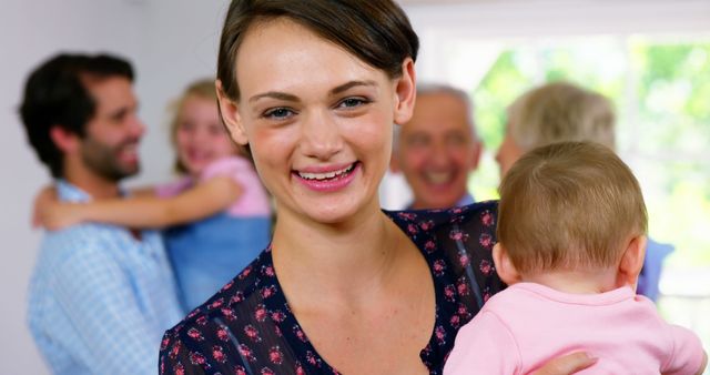 Happy Family Gathering at Home with Mother Holding Baby - Download Free Stock Images Pikwizard.com