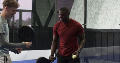 Friends Playing Padel on Court in Enthusiastic Coastal Vibe