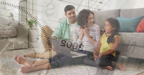 Young family sitting on living room floor sharing laptop with global map overlay concept