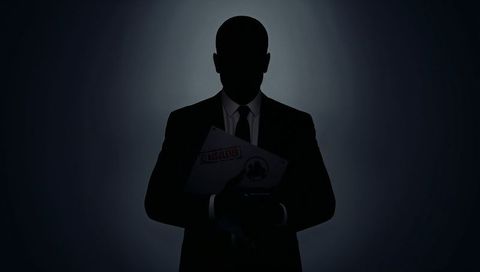 Backlit silhouette executive holding classified dossier, dramatic corporate secrecy