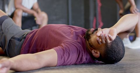 Exhausted man resting after intense gym session