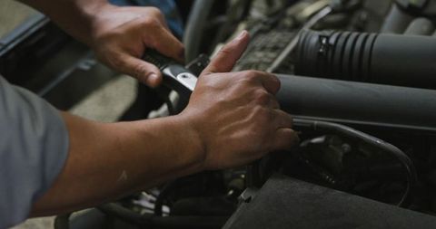 Mechanic Tightening Engine Intake with Ratchet Closeup Hands Forearms Wrench