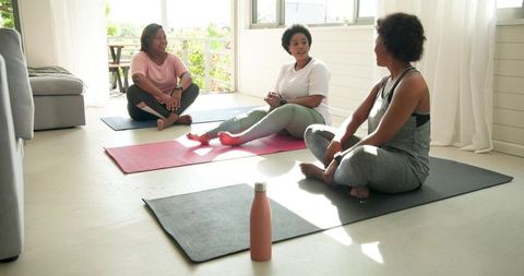 Friends Sharing Relaxing Moments After Home Yoga Session