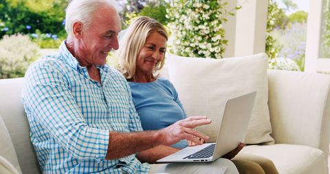 Senior Couple Engaged with Laptop in Cozy Living Room - Download Free Stock Images Pikwizard.com