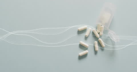 Spilled Pills with Digital Interface Overlays on Grey Background