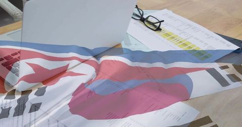 Red star flag overlay on office desk with laptop, highlighted spreadsheets and glasses