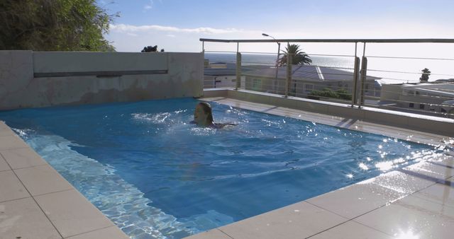 Woman Swimming in Outdoor Pool with Ocean View - Download Free Stock Images Pikwizard.com