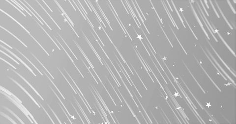Sweeping monochrome star trails creating abstract night sky motion background
