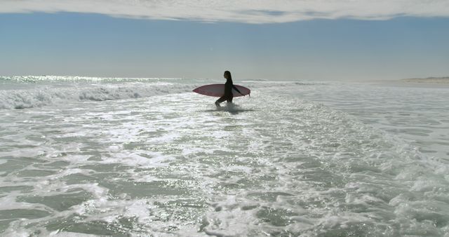 This image can highlight the adventurous spirit of surfing, making it excellent for promotions focused on beach activities, outdoor sports, and travel destinations. It emphasizes the appeal of a coastal lifestyle, making it fitting for surfing magazines, travel agencies, and sport gear advertisements.