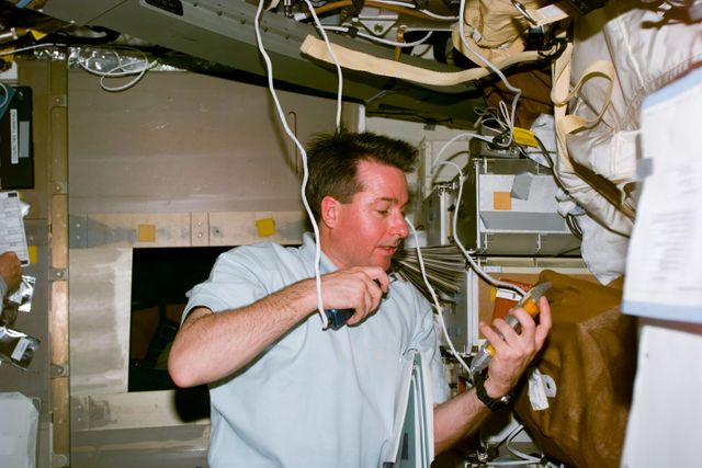 STS095-E-5149 (3 Nov. 1998) --- Astronaut Stephen K. Robinson, STS-95 mission specialist, talks to ground controllers in Houston from Discovery's middeck. The photo was taken with an electronic still camera (ESC) at 15:27:36 GMT, Nov. 3.