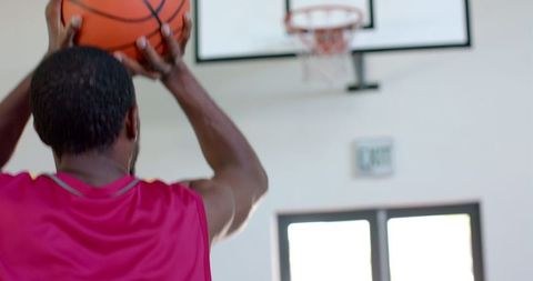 Athletic Man Playing Basketball Focuses on Scoring