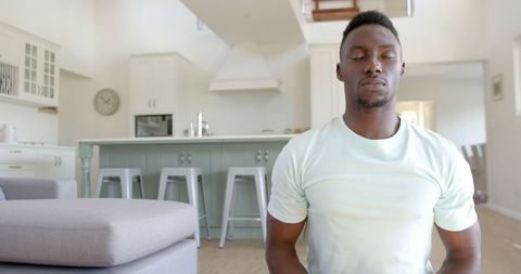 Serene Man Meditating in Modern Home Interior