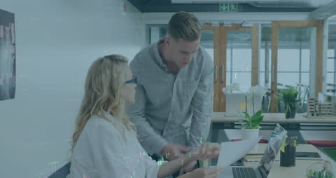 Colleagues Collaborating on Financial Report with Digital Interface