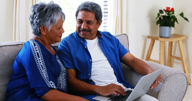 Senior Couple Using Laptop Together in Cozy Living Room - Download Free Stock Images Pikwizard.com