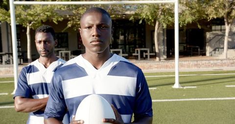 Determined Rugby Players Standing on Field in Matching Jerseys