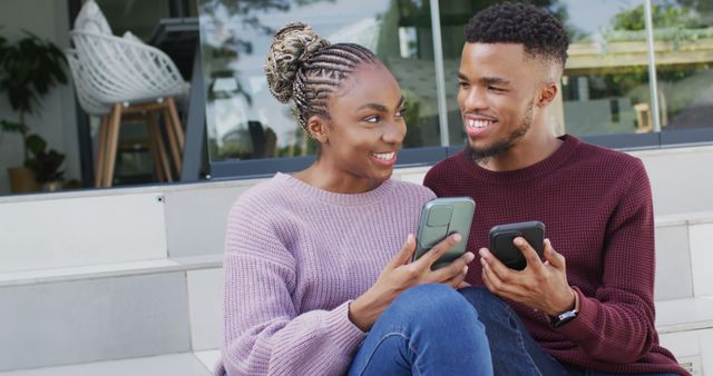 Happy african american couple talking and relaxing with smartphones outside house - Download Free Stock Photos Pikwizard.com