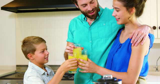 Family Toasting with Orange Juice in Kitchen Setting - Download Free Stock Images Pikwizard.com