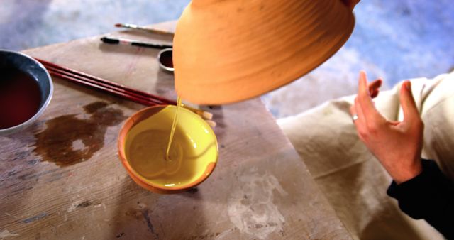 Artisan Pouring Varnish Into Ceramic Bowl in Pottery Workshop - Download Free Stock Images Pikwizard.com