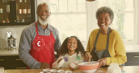 Grandparents baking with granddaughter in sunlit kitchen, mixing batter and smiling
