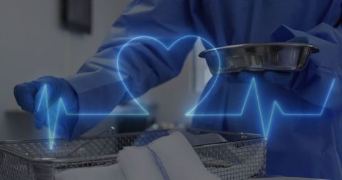 Surgeon preparing instruments with heart rate overlay
