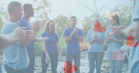 Diverse Volunteers Celebrating Conservation Efforts in Lush Forest