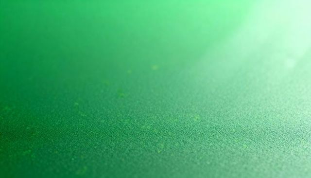 Macro green textured paper with yellow-green flecks, gradient lighting, abstract backdrop