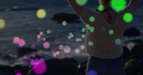 Woman Relaxing on Rocks with Colorful Light Reflection