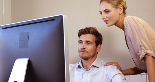 Colleagues Collaborating in Office on Computer - Download Free Stock Images Pikwizard.com