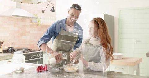 Couple baking together in modern pastel kitchen mixing batter with augmented ui overlay