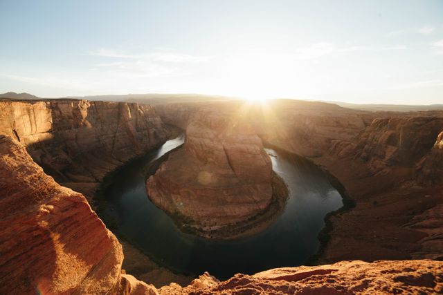 Spectacular view of Horseshoe Bend at sunset in Arizona's Grand Canyon. Useful for travel blogs, magazines, advertisements promoting tourism, nature posters, and educational materials about geological wonders.