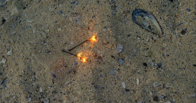 Sparklers Burning Brightly on Evening Beach Sand - Download Free Stock Images Pikwizard.com