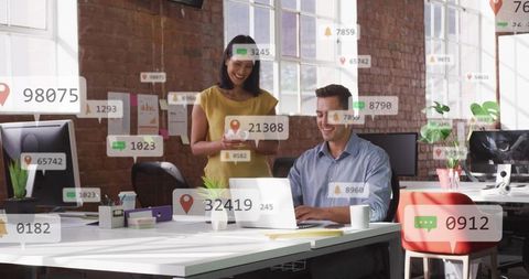 Team collaborating around laptop in bright open-plan office with floating data overlays