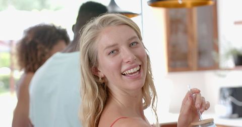 Young Woman Enjoying Casual Home Party Gathering with Friends