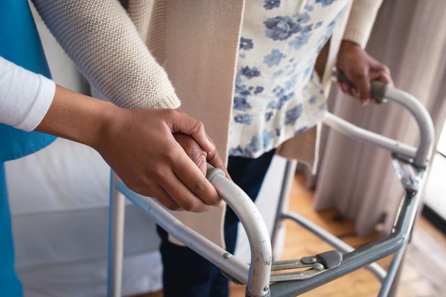 Physiotherapist assisting senior woman with a walking frame at home. Ideal for illustrating concepts of elderly care, home healthcare, rehabilitation, and physical therapy. Useful for articles, blogs, and promotional materials related to senior care, mobility aids, and healthcare services.