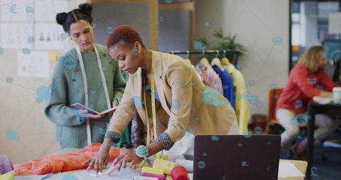 Collaborating fashion designers planning innovative clothing patterns