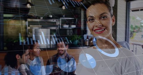 Smiling businesswoman analyzing digital graphs in trendy coffee shop