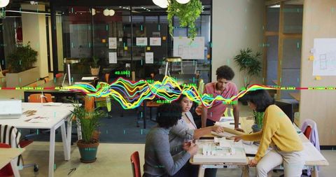 Designers Collaborating in Modern Office with Digital Data