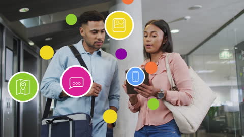 Diverse Coworkers Using Tablet in Modern Office with Digital Icons