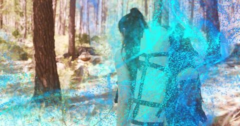 Solo hiker walking sunlit pine forest carrying backpack with turquoise glow overlay