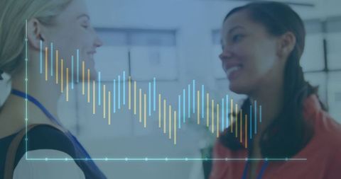 Businesswomen Discussing Data with Digital Bar Chart Overlay