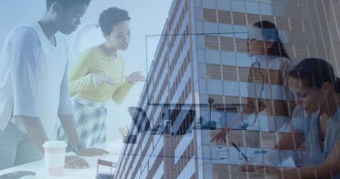Leading women collaborating at boardroom table with urban glass building overlay