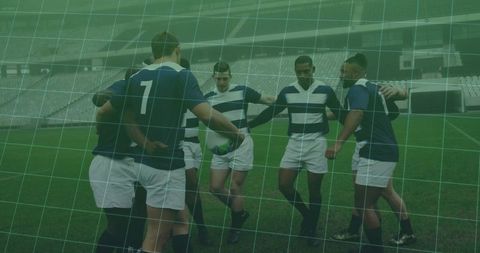 Team bonding: rugby team huddles in empty stadium for match strategy