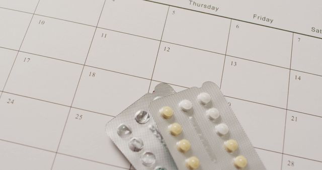 Birth Control Pills with Monthly Calendar in Background - Download Free Stock Photos Pikwizard.com